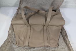 An as new Cortana Folded Leather Bag - Beige.
