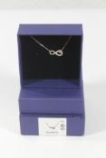 An as new boxed Swarovski Infinity white necklace (5520576).