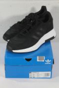 An as new pair of Adidas Retropy F2 Trainers in Black/White, Size UK 11.5 (Box Damaged).
