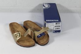 A pair of as new Birkenstock Madrid BS Sandals in Gold, Size UK 7.5 (Box Damaged).