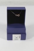 An as new boxed Swarovski Infinity white necklace (5520576).