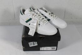 An as new pair of Adidas Busenitz Trainers in White/Green, Size UK 10 (Box Damaged).