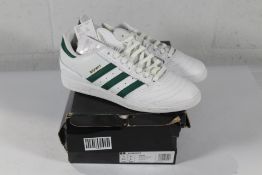 An as new pair of Adidas Busenitz Trainers in White/Green, Size UK 8.5 (Box Damaged).