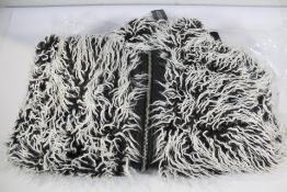 An as new Dolls Kill Need No Protecting Faux Fur Jacket (L).