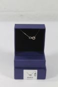 An as new boxed Swarovski Infinity white necklace (5520576).