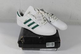 An as new pair of Adidas Busenitz Trainers in White/Green, Size UK 9.5 (Box Damaged).