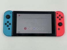 A pre-owned Nintendo Switch Console (HAC-001-01) 32GB with Neon Blue/Red Joy-Con Controllers (No cha