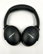 A pre-owned pair of Bose QuietComfort 45 Noise Cancelling Wireless Headphones with storage pouch.