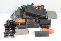 A quantity of Assorted Sunglasses, Clothes and Bags.