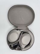 A pre-owned pair of Sony WH-1000XM4 Wireless Noise Cancelling Headphones with case.
