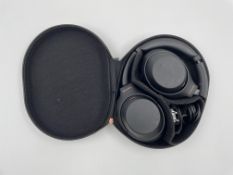 A pre-owned pair of Sony WH-1000XM4 Wireless Noise Cancelling Headphones with case.