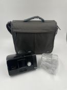A pre-owned ResMed AirSense 10 AutoSet CPAP Machine with power adapter, tubing & water unit in padde