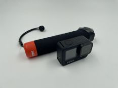 A pre-owned GoPro HERO9 Black Camera with battery, floating handle, USB-C cable & storage pouch.