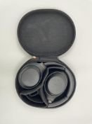 A pre-owned pair of Sony WH-1000XM4 Wireless Noise Cancelling Headphones with case.