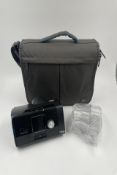 A pre-owned ResMed AirSense 10 AutoSet CPAP Machine with power adapter, tubing & water unit in padde