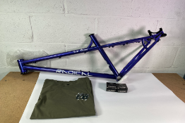 Radical Grim Ripper bike frame in purple (Regular Size) and a Radical Co. bicycle t-shirt (Medium).