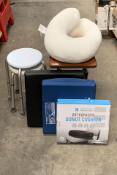 An adjustable over bed table, two adjustable shower stools, two chair pressure cushions and an ortho