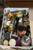 A box of assorted food items to include Jams, Oils and Syrups.
