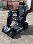 A pre-owned TGA Vita S mobility scooter with key, charger and universal sun and rain cover.