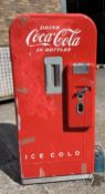 A vintage Coca Cola Bottle Vending Dispenser. In need of restoration or for decoration.