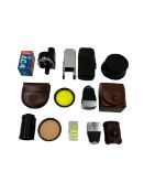 Assorted vintage camera accessories.