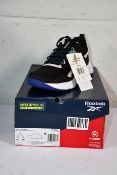 A pair of boxed Reebok Memerytech Comfortbed CBLACK/FTWWHT/BOLPRP NFX trainers (UK 4.5).