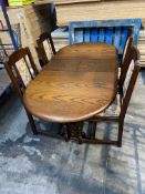 A pre-owned dark wood extending dining table and four upholstered seat and back chairs.