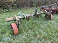 Cousins twin leg pan buster with depth wheels, linkage mounted