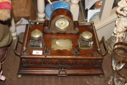 An Edwardian carved oak desk stand with integral c