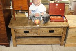 An oak coffee table fitted two drawers