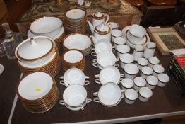 A Noritake gilt banded dinner service