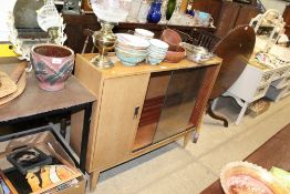 A teak bookcase with sliding glass doors