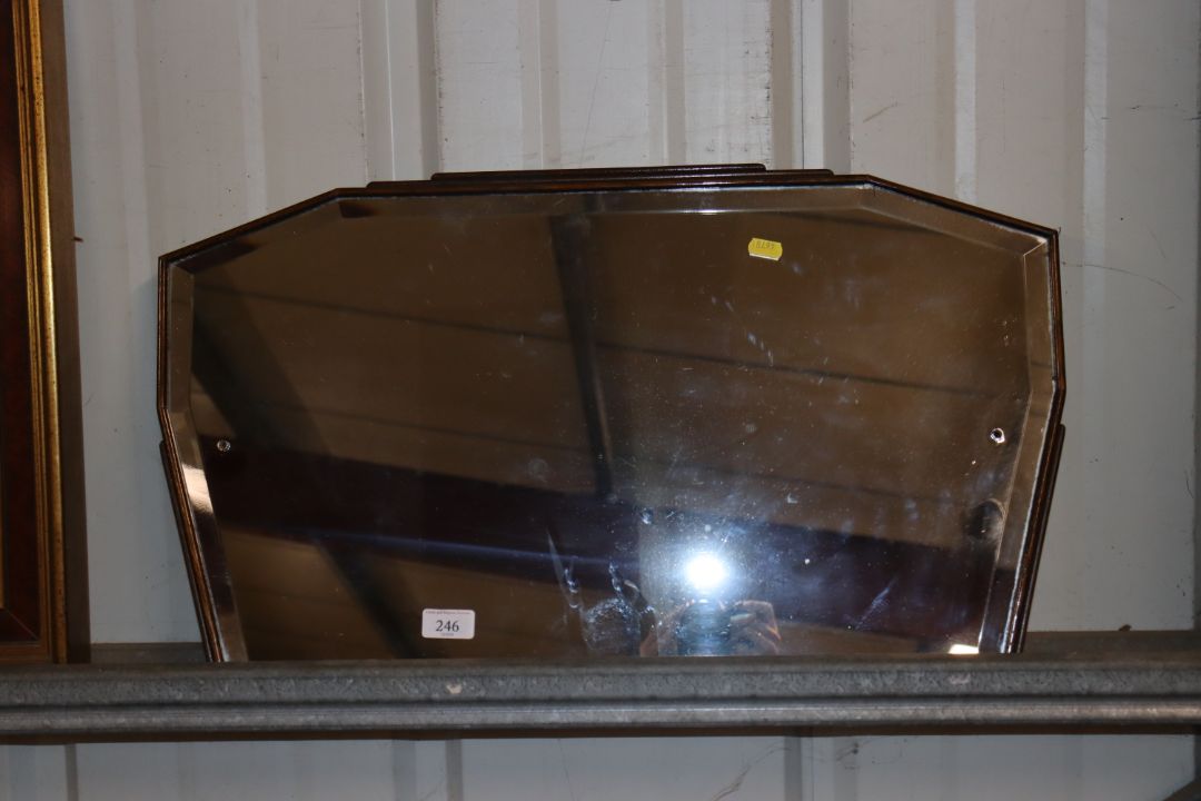 An Art Deco oak framed bevel edged wall mirror