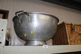 A large aluminium colander