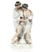 A large Staffordshire figure depicting a Bacchanalian couple, on plinth base, 64cm high