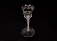 Two Georgian drinking glasses, with spiral twist stems; another with foliate etched vine and bird