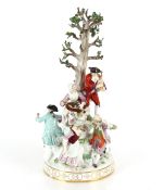 A large 19th Century Meissen figure group depicting villagers dancing and drinking before a floral