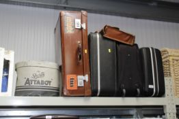 A collection of suitcases and a hat box