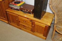 A modern pine cupboard fitted two drawers