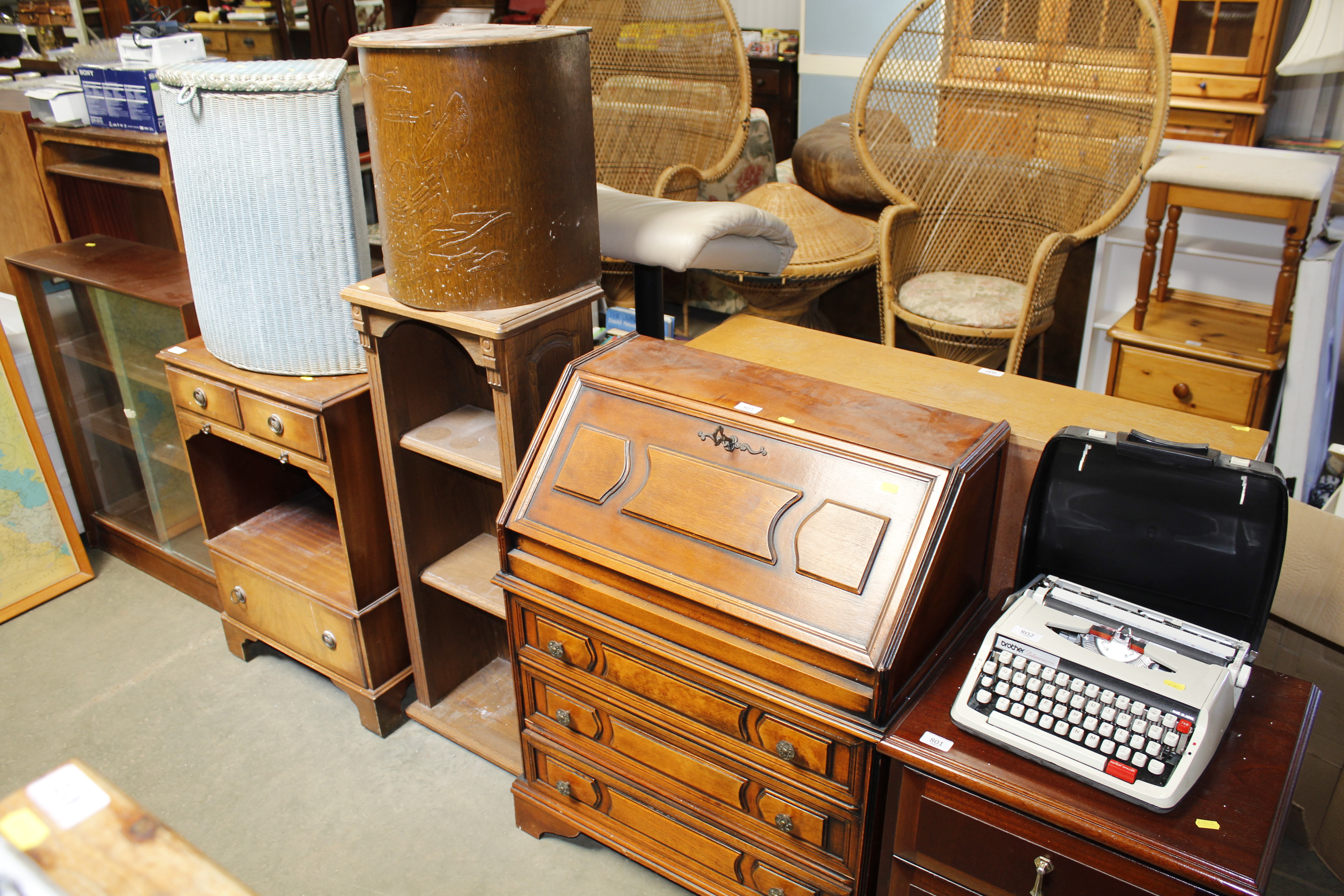 An oak bookcase, a bureau fitted three drawers and