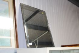 A frameless bevel edged wall mirror