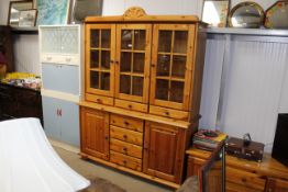 A modern pine and glazed dresser