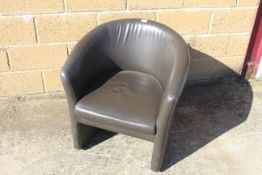 A leather effect tub shaped armchair SUBJECT TO VAT