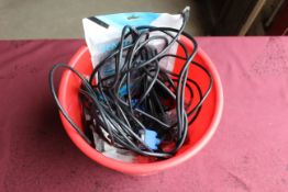 A bucket containing various cables to include, Ethernet, VGA, a hole punch, stapler, etc. SUBJECT TO