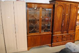 A mahogany display cabinet with adjustable glass s