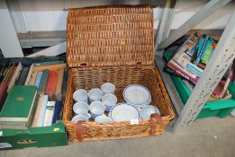A wicker hamper and contents of teaware