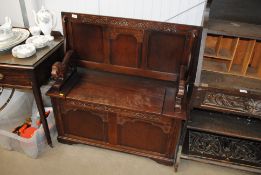 A carved oak monks bench