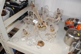 A glass five light chandelier with decorative pris