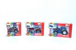 A Britains Ford TW 25 tractor No.9508; Britains Massey Ferguson MF 3680 tractor No.9501 and Britains