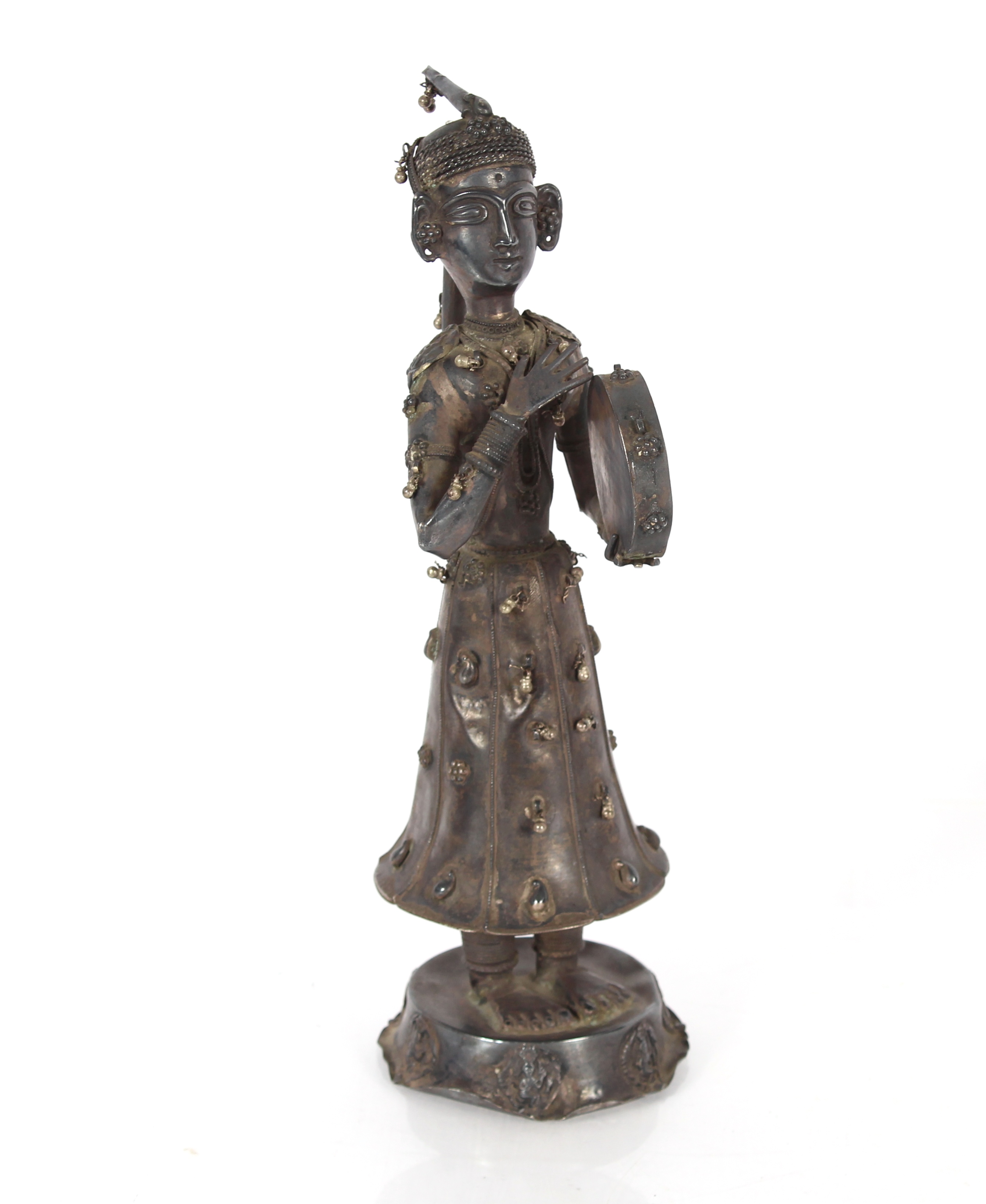 A 19th Century Indian silver figure of a musician, 30cm high